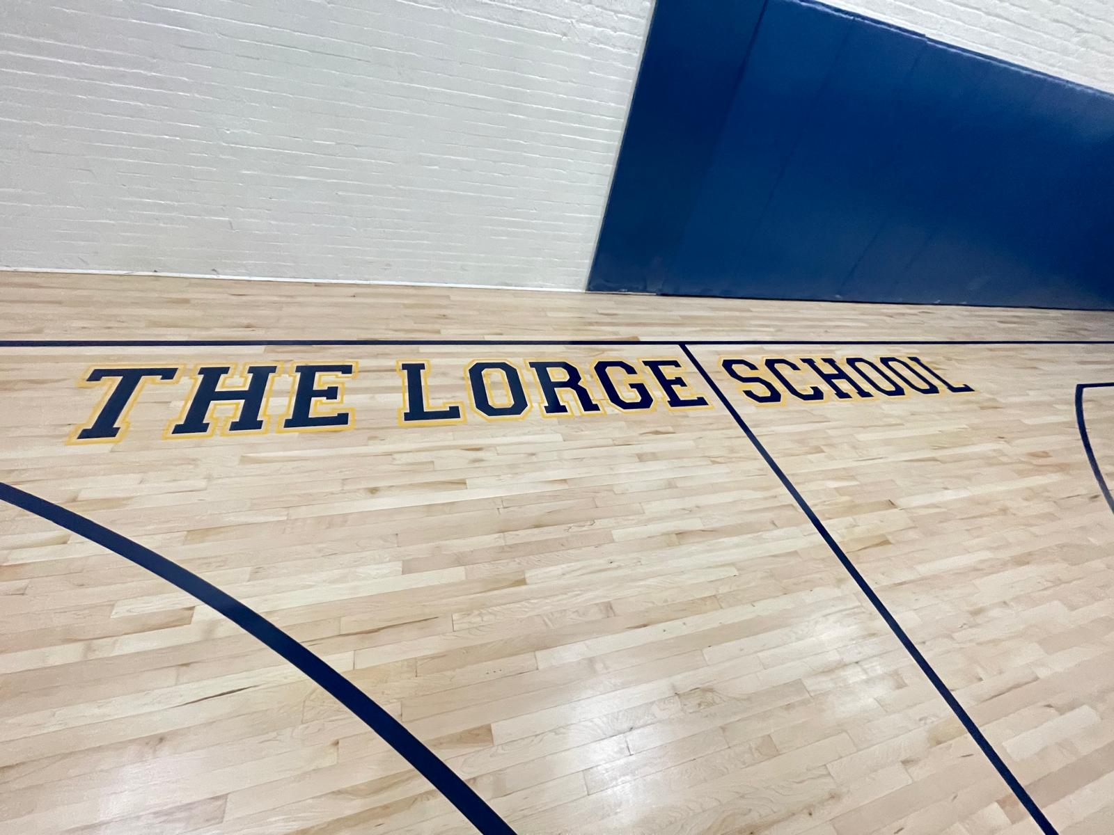 Close-up of hand-painted navy and gold THE LORGE SCHOOL lettering