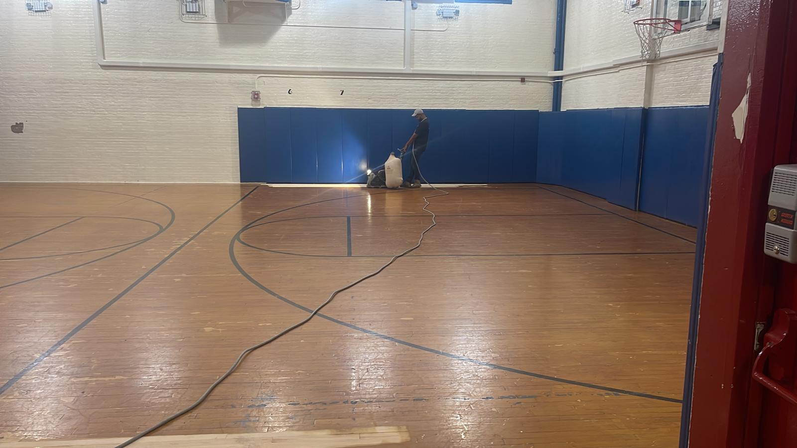 Restoration in progress — cleaning and prepping the court surface
